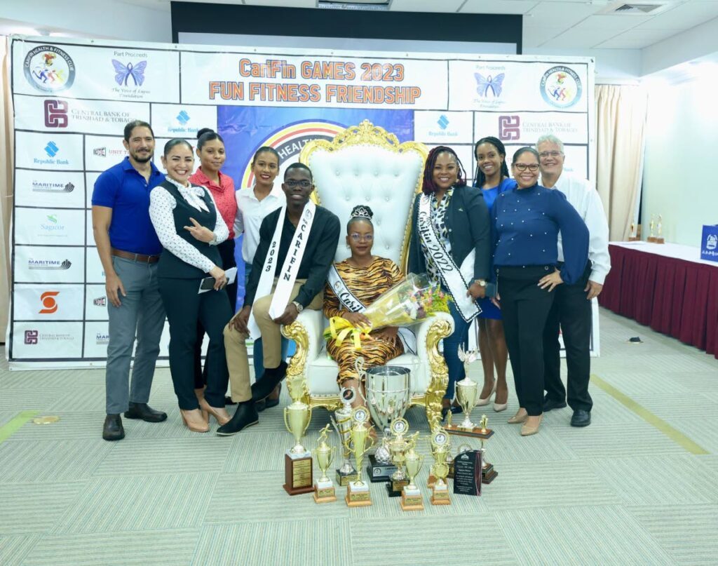 Team Sagicor poses with the winners of Mr and Ms CariFin competitions Jaden Richards, seated left, and Keziah Mc Shine - 