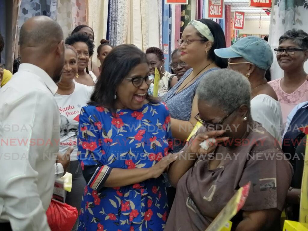 Minister of Trade Paula Gopee-Scoon speaks with a recipient of the Lutterloh pattern system kits at a distribution at Jimmy Aboud's cloth store in Port of Spain - Photo by Ryan Hamilton-Davis