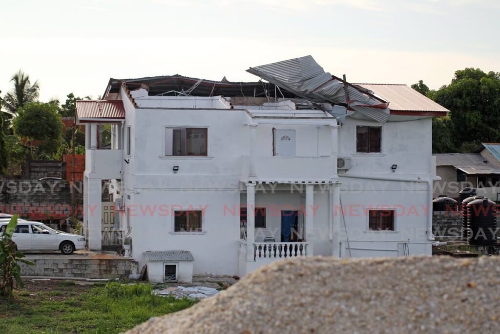 RIPPED OFF: Part of the roof of this home at Phekoo Avenue Bonne Aventure Gasparillo was blown off by strong winds on Thursday.  - Lincoln Holder