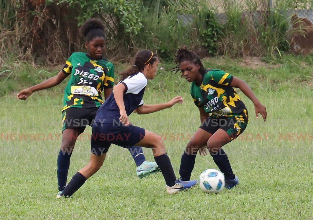 Katelyn Darwent of St Joseph's Convent dribbles Diego Martin Central's Naima Julius and Faith Williams during a SSFL game at Diego Martin Central ground, Thursday.  - ROGER JACOB