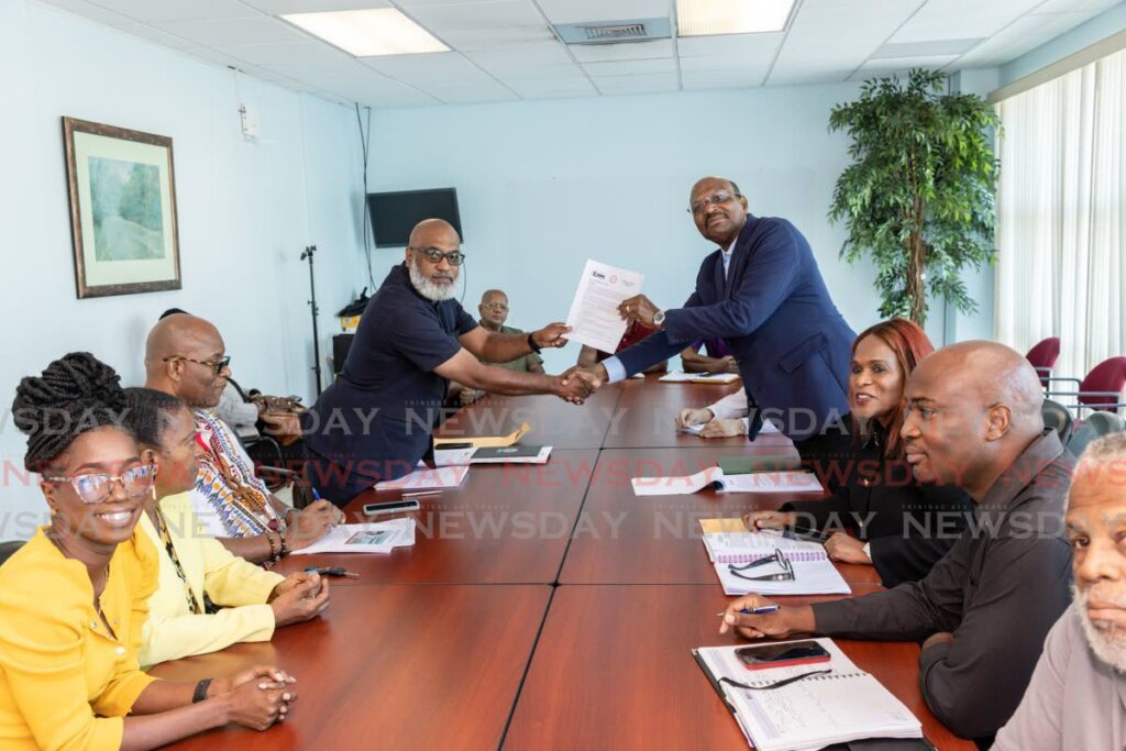 JTUM's general secretary Ozzi Warwick presents UNC senator Wade Mark with JTUM's budget recommendations and proposals ahead of the 2023/2024 budget during a meeting at Office of the Leader of the Opposition, Port of Spain on Friday. - Photo by Jeff K. Mayers