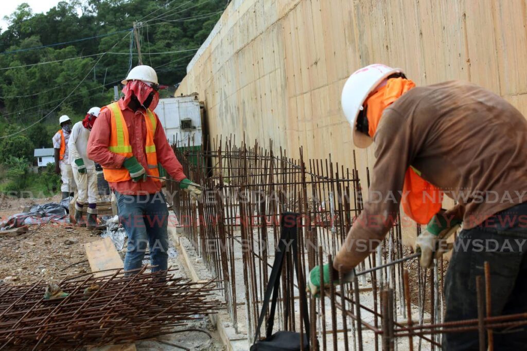 Workers at a construction site in 2021. FILE PHOTO - 