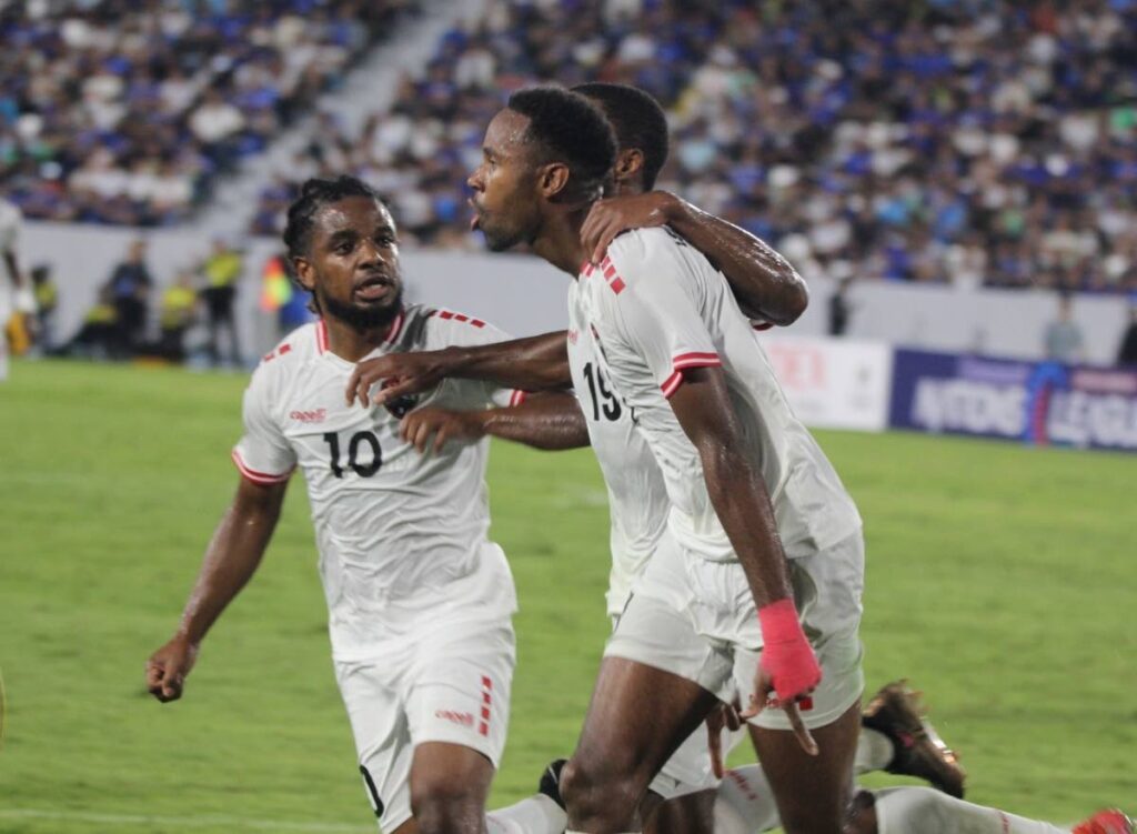TT’s Justin Garcia, right, celebrates his goal against El Salvador in a Concacaf Nations League game on September 10 at the Nacionel Jorge Magico Gonzalez Stadium, El Salvador. TT’s Duane Muckette, left, and Malcolm Shaw join in the celebrations.  - TTFA Media