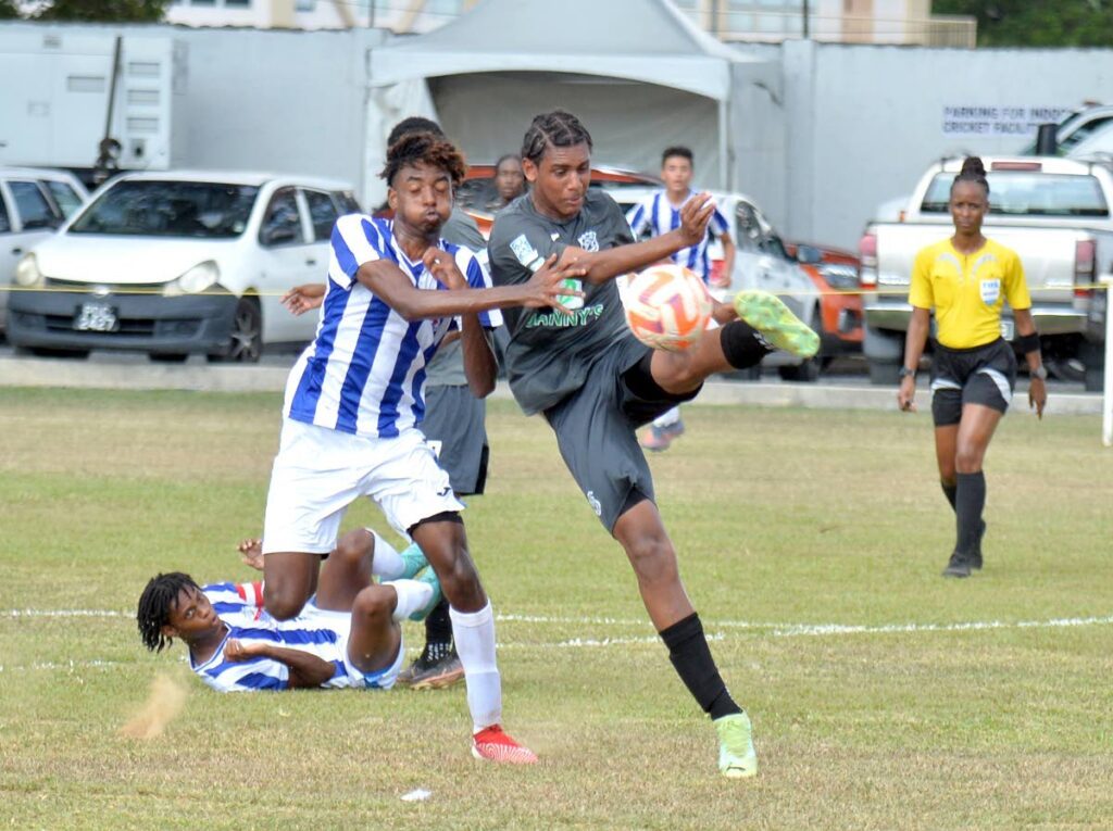 A Naparima College player kicks the ball under pressure from his St Mary's rival during a SSFL clash at St Mary's Ground, St Clair, earlier this season. - Dennis Allen for @TTGAMEPLAN