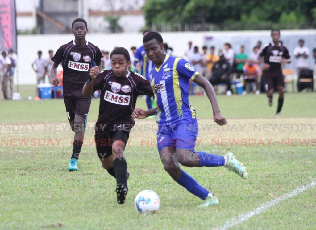 In this September 20 photo, Fatima College’s Micaiah Leach (R) and East Mucurapo Secondary’s Jemon Gulston battle for possession during a Secondary Schools Football match, at Fatima Grounds, Mucurapo. On Saturday, Fatima beat San Juan North Secondary 5-2 in Round Six of the SSFL’s Premiership Division. - Ayanna Kinsale
