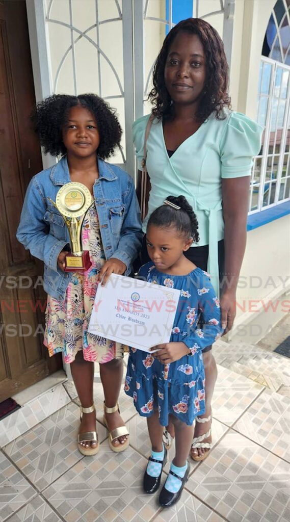 Chloe Boodram, left, of Miracle Ministries, the daughter of Christopher Boodram who survived the Paria diving tragedy, was awarded for her achievements in SEA. Her mother Candy Stoute-Boodram and sister Cierra accompanied her to the event hosted by the Presbyterian School Board, at the Susamachar Presbyterian Church in San Fernando on Saturday. - Yvonne Webb