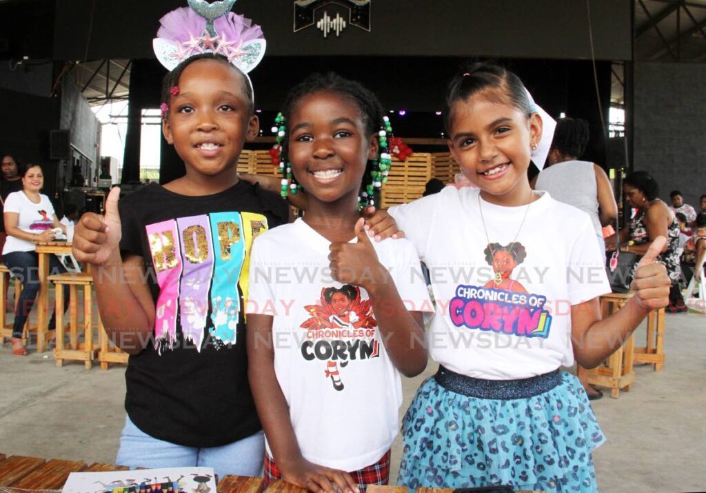 Author Coryn Clarke, centre, with her friends Skyy, left, and Alyssa Ramoutar at the Chronicles of Coryn Children's Book Festival at Sound Forge, Port of Spain, on October 1. - Ayanna Kinsale