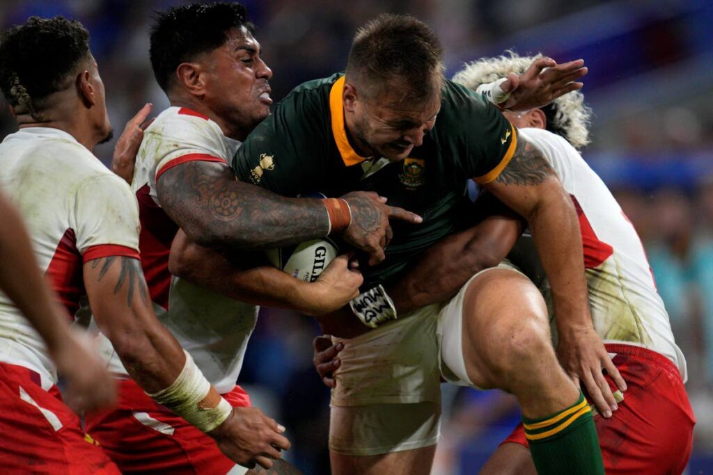 South Africa's Andre Esterhuizen, front, is tackled by Tonga's Malakai Fekitoa, left, and teammate Fine Inisi during the Rugby World Cup Pool B match at the Marseille's Stade Velodrome, in Marseille, France last Sunday. - AP