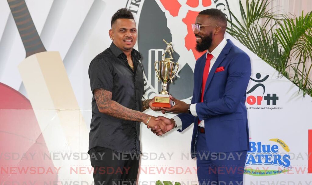 Queen's Park spinner Sunil Narine, left, collects an award from CWI Director of Cricket Miles Bascombe at the TTCB Awards, Center Point Mall auditorium, Chaguanas, Saturday. - Photo by DANIEL PRENTICE
