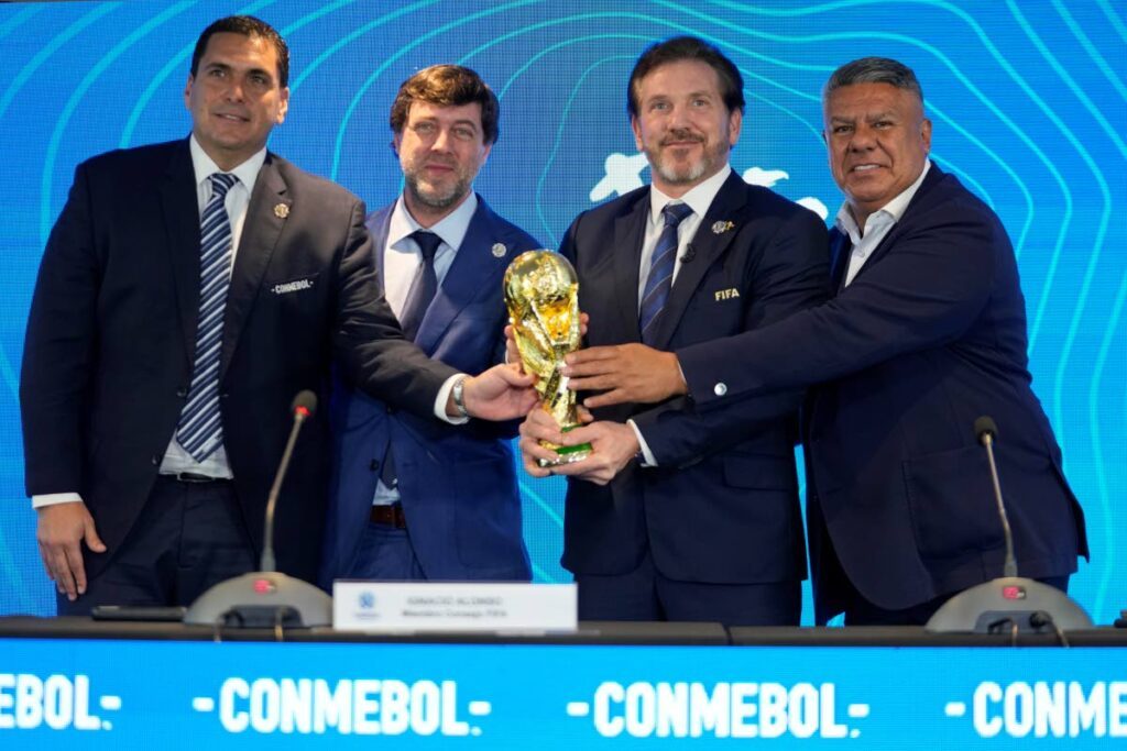 Paraguay's Football Association president Robert Harrison (L) FIFA delegate Ignacio Alonso (C) Conmebol President Alejandro Dominguez (3L) and Conmebol Vice President Claudio Tapia hold the World Cup  tournament trophy in Luque, Paraguay, on Wednesday. The press conference was to announce that some of the World Cup 2030  tournament matches will be played in Argentina, Uruguay and Paraguay.  - AP PHOTO