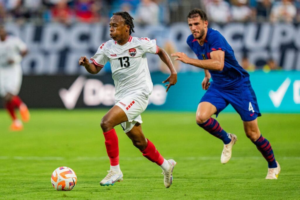 Trinidad and Tobago's Real Gill dribbles the ball past Matt Miazga of United States during their Gold Cup game at Bank of America Stadium on July 2, in Charlotte, North Carolina.  - 