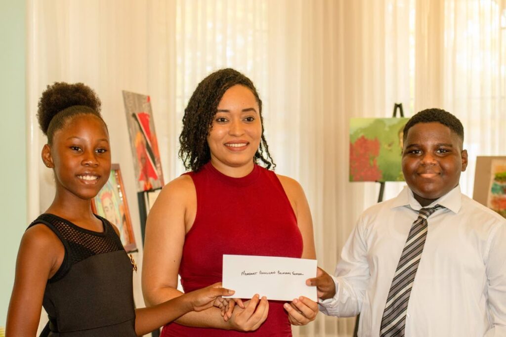 Pupils from Morvant Anglican Primary School receive the first-prize award for the 2022 Primary School parang competition from NPATT secretary Jenais Carter at Mille Fleurs, Port of Spain. - 