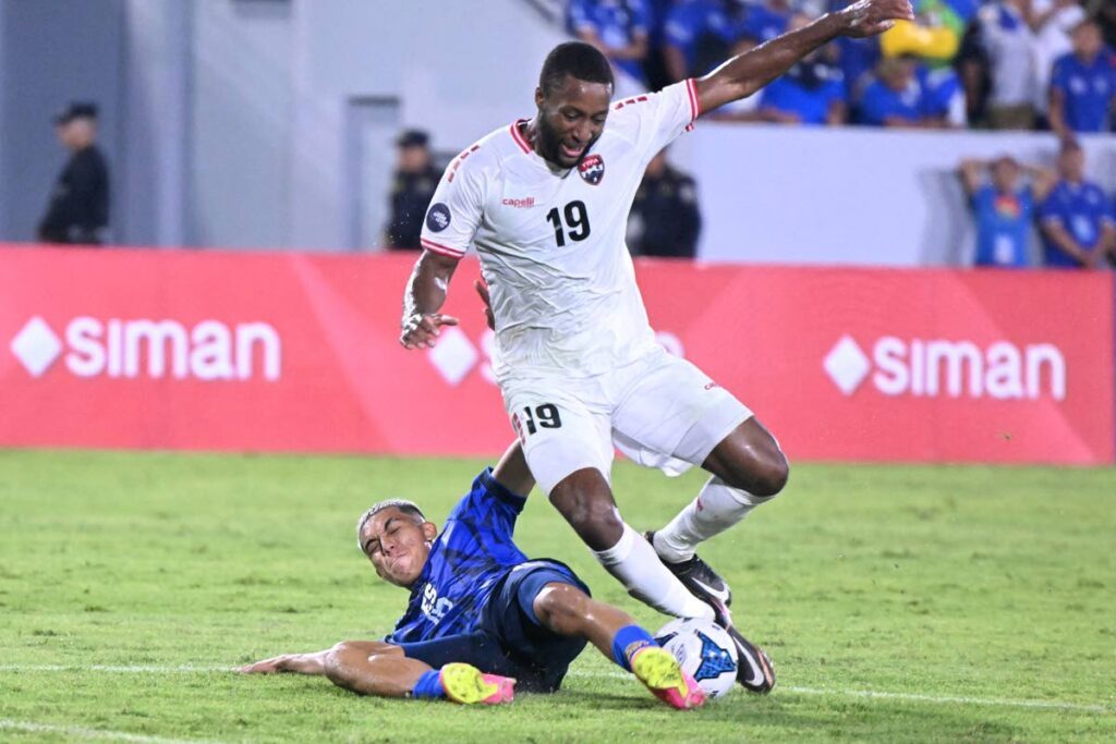 Trinidad and Tobago forward Malcolm Shaw, right, is tackled by El Salvador's Alejandro Henriquez in a Concacaf Nations League match on September 10, at the Jorge 