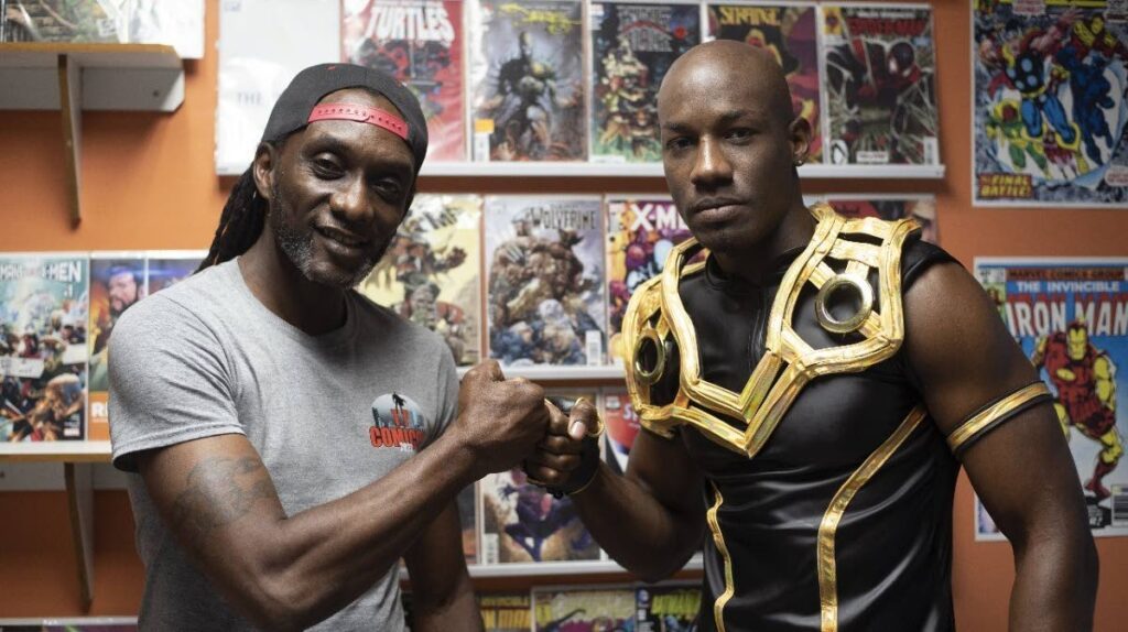 One of TT Comicon's organisers Michael Abraham, left, with actor Jumael James in costume as the superhero Vaser Claw.  - 