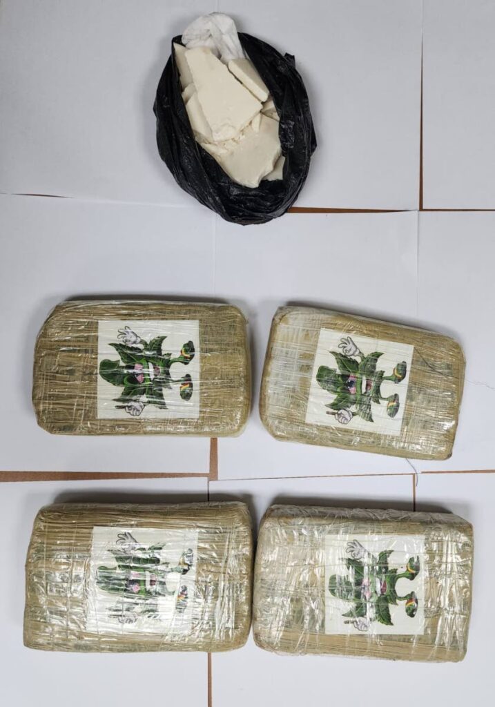 Four packages of marijuana and a bag with cocaine which was seized by police during a search of a house in Couva. - Photo courtesy TTPS