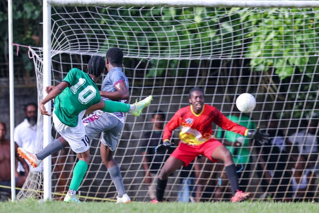 San Juan North Secondary Lindell Sween (L) volleys home his first goal against Bishop’s High during the Secondary School Football League Premiership match at the San Juan North Secondary grounds, on Saturday, in San Juan. Sween scored a hat-trick in San Juan North Secondary’s 6-0 win.  - Daniel Prentice