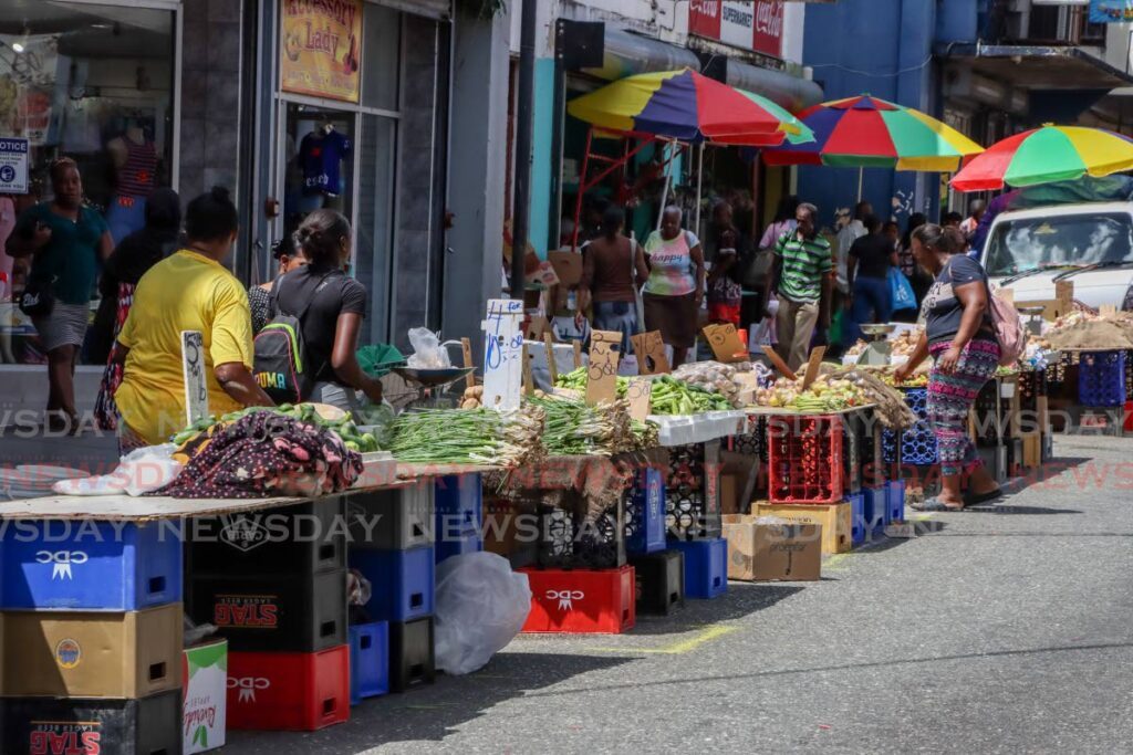 Vendors sell vegetables on Charlotte Street, Port of Spain on Tuesday. - Jeff Mayers