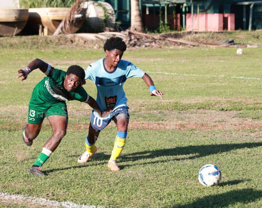 A St Augustine player tussles with his El Dorado East rival for the ball in a Secondary Schools Football League East Zone Championship match, at St Augustine Secondary ground, Tuesday. - Jeff K Mayers