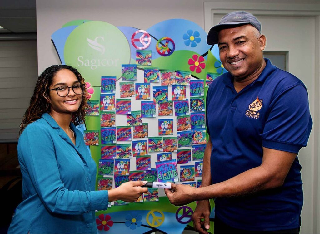  Sagicor Life Insurance TT Ltd customer service representaive Shania Pragg presents a client with a token as part of Customer Service Week.