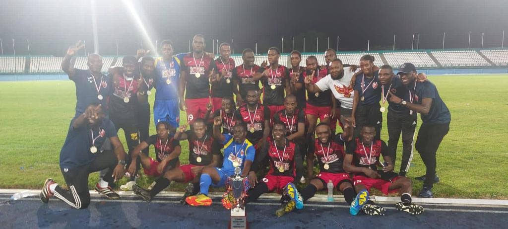 1976 Phoenix FC players and officials celebrate after winning the final of the TT Premier Football League Tier II tournament, against Petit Valley-Diego Martin United, on Tuesday, at the Dwight Yorke Stadium, Bacolet.   - 