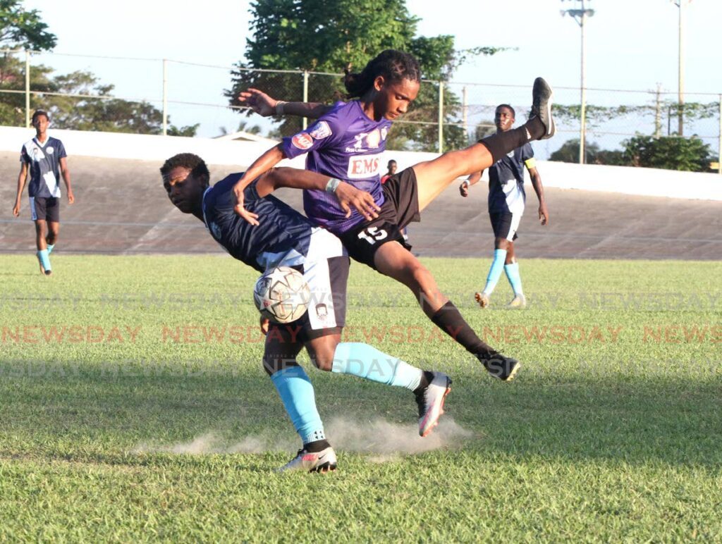East Mucurapo Secondary’s Clinton Latchman lands on top of Arima North Criston Gomez during the Secondary Schools Football League Premiership Division match, at the Arima Veledrome, on Wednesday. The match ended 0-0.  - Ayanna Kinsale