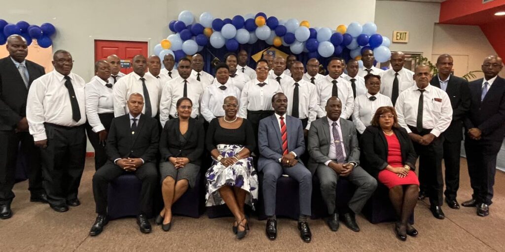 (Seated From Left to Right): Manager, Immigration Detention Centre, Ministry of National Security,  Bhojnarine Kandha, Deputy Permanent Secretary, Ministry of National Security, Aarti Bedassie-Maharaj, Director, Office of Law Enforcement Policy, Ministry of National Security, Gale Charles, Minister of National Security, Fitzgerald Hinds, Deputy Director, Office of Law Enforcement Policy, Allan Meiguel and Chief Immigration Officer, TT Immigration Division, Vera Persad, flanked by trainers, instructors and newly graduated Immigration Detention Officers. - 