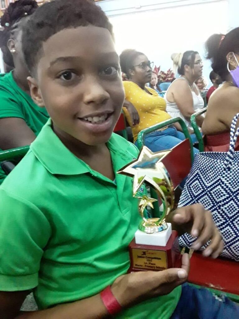 Jaydon Diaz shows off his trophy for Best Marac Player at the 2022 National Parang Association of TT's Primary School’s Parang Festival. - 