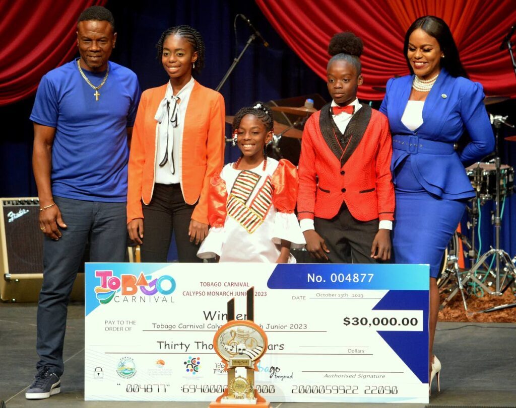 Assistant Secretary in the Division of Education, Research and Technology Orlando Kerr, with top three winners of the Junior Calypso compeition - Atiya Lynch, N'yah Arnold, D'ashe Saul - and Education Secretary Zorisha Hackett.  - 