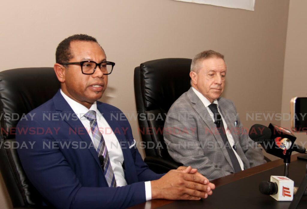 WASA's chief executive Kelvin Romain, left, speaks to the media during a press conference on the planned shutdown of the desalination plant at Desalcott , corner of Pacific Avenue and Maracaibo Drive, Point Lisas Industrial Estate. Looking on is Desalcott's general manager John Thompson. - Photo by Ayanna Kinsale