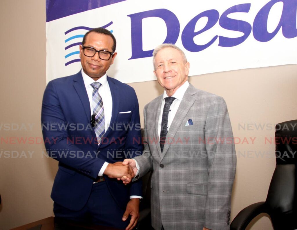 WASA's chief executive Kelvin Romain, left. and Desalcott's general manager John Thompson shake hands during a press conference on the planned shutdown of the desalination plant at Desalcott, corner of Pacific Avenue and Maracaibo Drive, Point Lisas Industrial Estate.