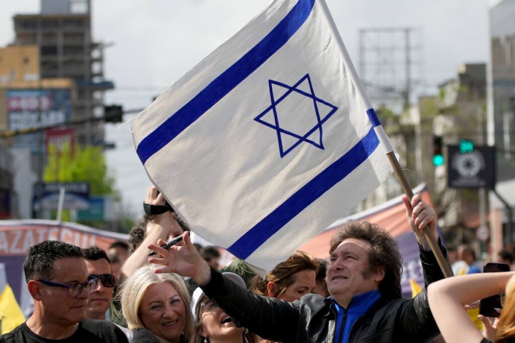 Presidential hopeful Javier Milei, of the Liberty Advances coalition, holds an Israeli flag during his campaign rally in Lomas de Zamora, Argentina, on Monday. General elections are set for October 
22.  - AP PHOTO