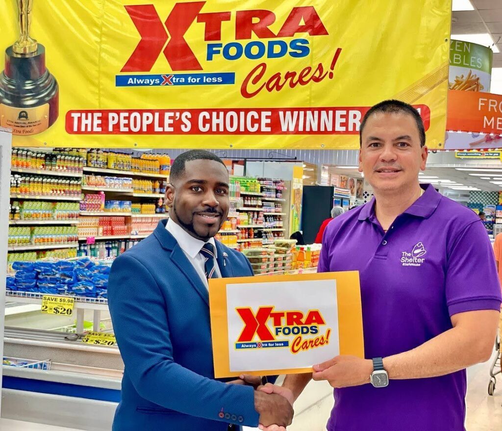 Daniel Austin, marketing manager, Xtra Foods, left, pledges generous donation to Colin Mitchell, chairman of The Shelter. - 