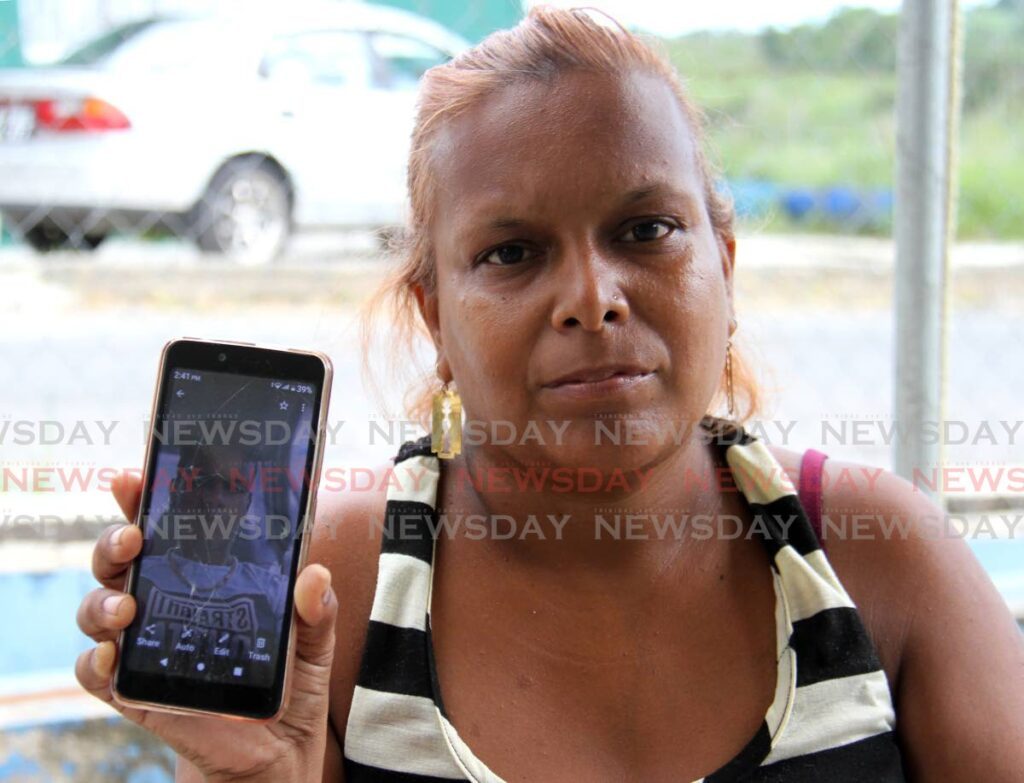 Shellyann Smith shows a photo of her son Ancil Lewis Smart in Diamond VIllage. Smart's body washed ashore on Monday at the Clifton Hill beach Point Fortin. - Photo by Ayanna Kinsale