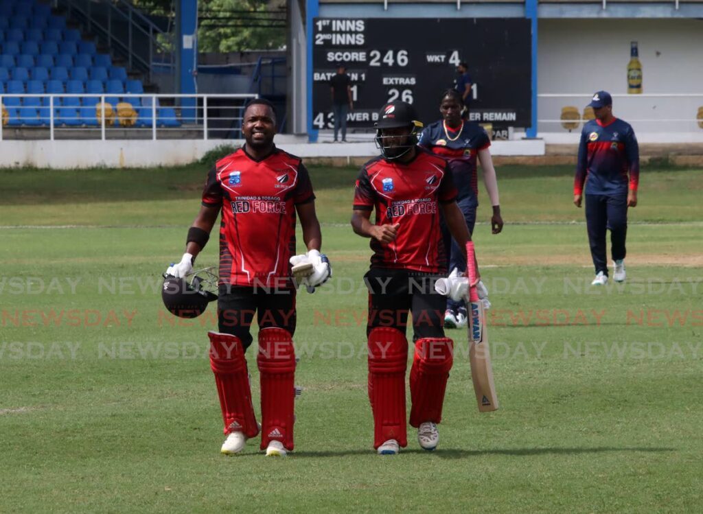 TT Red Force captain Daren Bravo (L) and batsman Yannic Cariah leave the field at the end of their innings, on Tuesday, against the Combined Colleges and Campuses Super50 match, at the Queen’s Park Oval, St Clair.  - ROGER JACOB