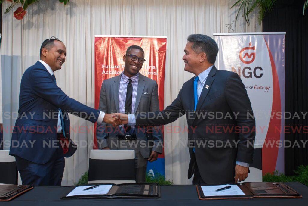 Methanex's Trinidad managing director Colin Bain  shakes hands with NGC president Mark Loquan, while Caribbean Ideas Group CEO Chike Farrell looks on.
Photo courtesy NGC - 