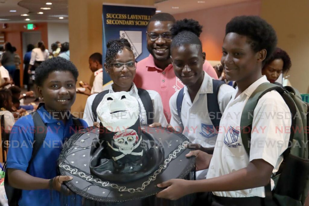 Ladian Majeed, Jamille Michel, Reon McFarlene and Joshua Murphy of Success Laventille Secondary showcase some of the works created under the art and craft sessions. The Education Ministry had a special ceremony to celebrate the achievements of pupils and students who participated in the Laventille/Morvant School Improvement Project. - Photo by Roger Jacob