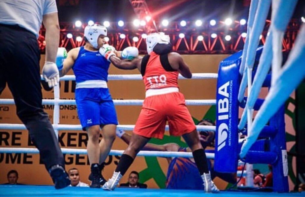 TT boxer Angel George (R) lands a punch during her World Championship bout in India in March, 2023.  - 