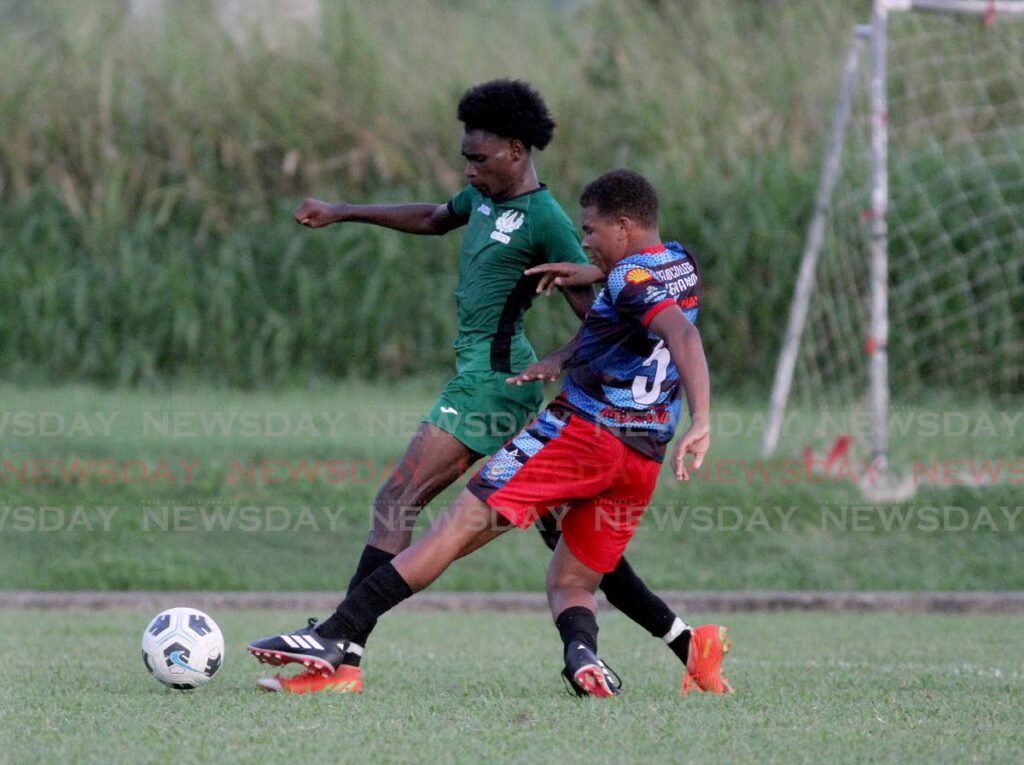 ASJA Boys’ College’s Torres Ramjattan, right, tackles St Madeleine Secondary’s Tyrell Dyeth during a Secondary Schools Football League Championship match at the Manny Ramjohn Stadium, Marabella, Friday. Ste Madeleine won 3-2. - AYANNA KINSALE