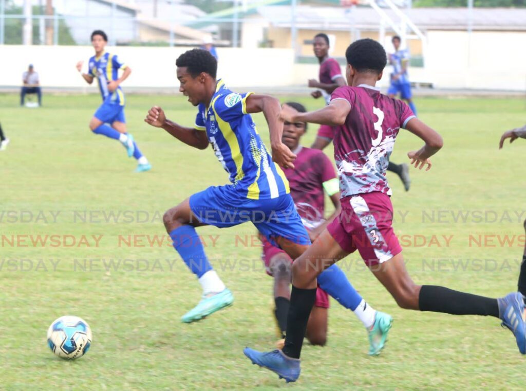 Joshua Mason of Fatima College, left, skips over tackles from Bishop's High School's Kerron Arthur and Mikael Frank, during their Secondary School Football League's Premier Division match, at Fatima Grounds, Mucurapo Road, last Saturday.  - Angelo Marcelle