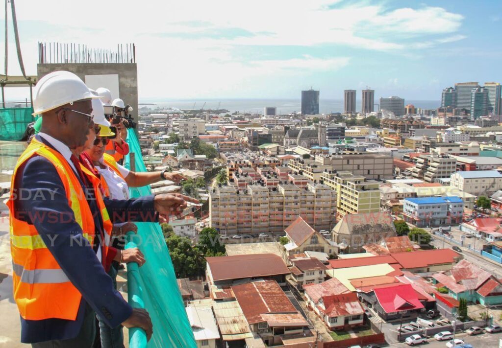 HIGH HOPES: Prime Minister Dr Keith Rowley, left, and Minister of Health Terrence Deyalsingh enjoy the view of the city from the top of the new Central Block of the Port of Spain General Hospital during its official topping off ceremony on Monday.  - Ayanna Kinsale