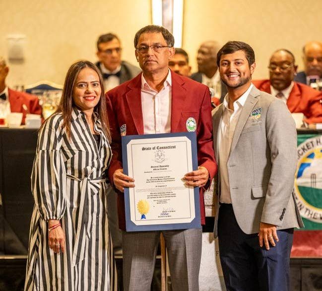 Jayesh Patel, centre, flanked by his wife Sima and son Param after receiving his Hall of Fame award. Photo by Dharmendra Solanki.
 - 
