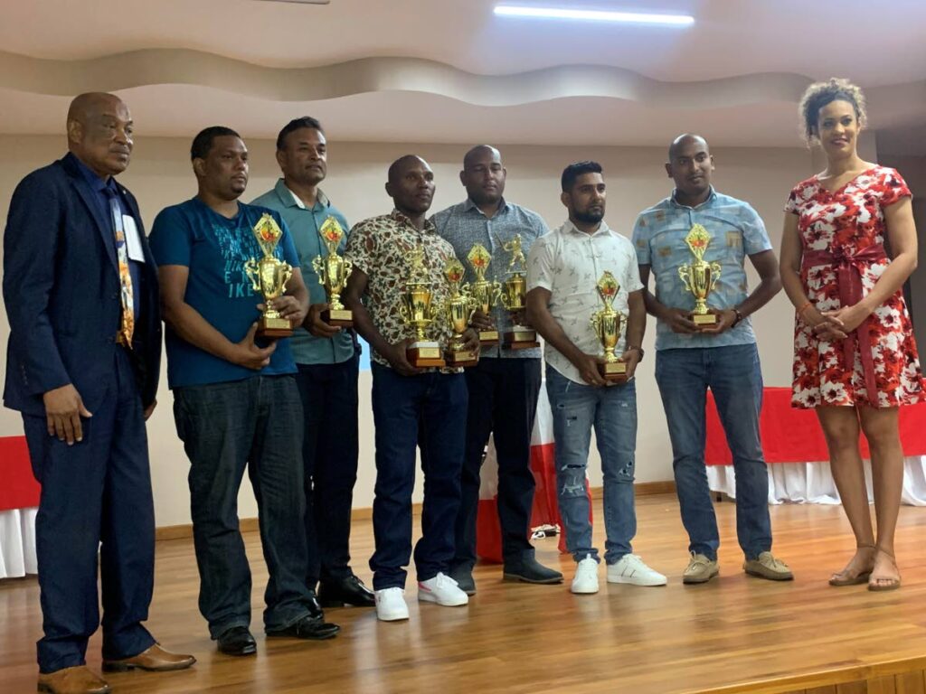 East Zone cricket awardees are flanked by zone chairman Sam Phillip, left, and MP for St Augustine Kadijah Ameen, right. Second from left are Sterling Seebransingh, Kester Hanooman, Neil Williams, Keston Skeete, Kevin Lalta and Stephen Gopie.   - TTCB