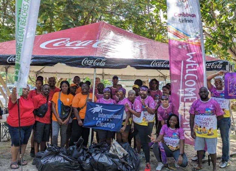 Caribbean Airlines' team members in Barbados during the coastal clean-up exercise. - 