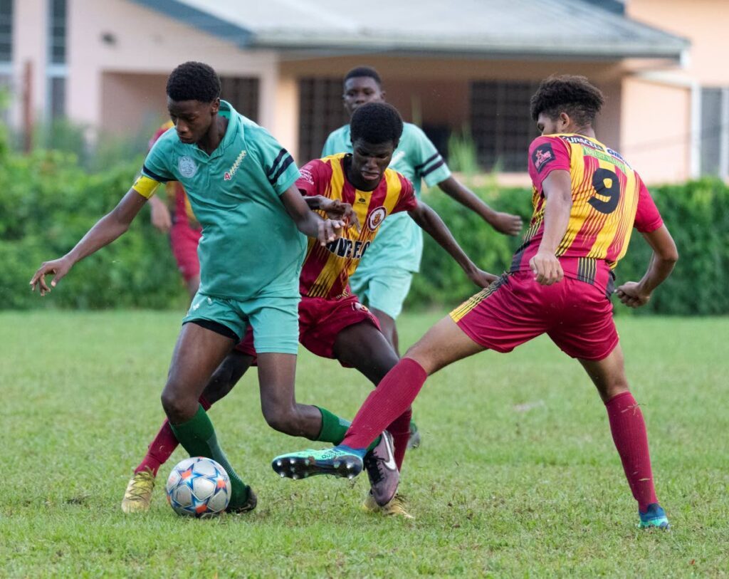 An Arima North Secondary player dribbles between two Hillview players in an Under-16 Intercol semifinal on Monday in Bourg Mulatresse. Photo by Dennis Allen for @TTGameplan - 
