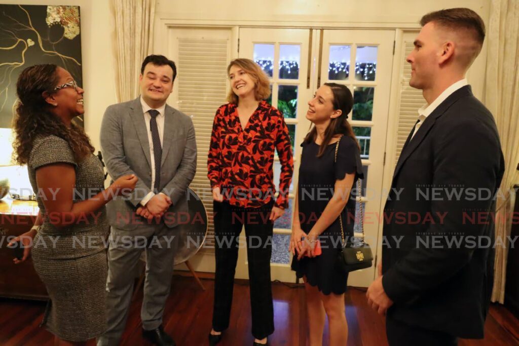 British High Commissioner to TT Harriett Cross, centre, speaks with Finastra executives at a networking event on Tuesday at her residence in Maraval.  - ROGER JACOB