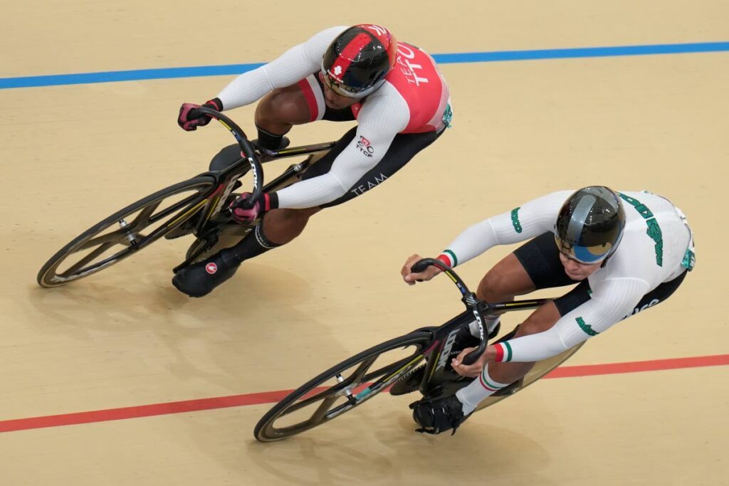 Mexico's Juan Ruiz, right, races Trinidad and Tobago's Nicholas Paul in the men's cycling track sprint qualifier at the Pan American Games in Santiago, Chile, Wednesday. - AP PHOTO