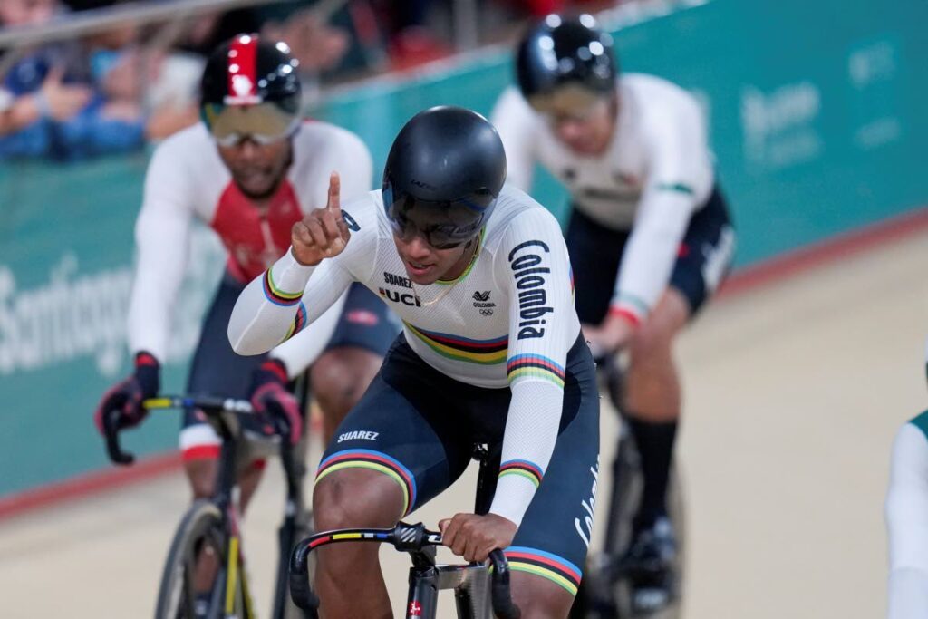 Colombia's Kevin Quintero celebrates winning the gold medal in the cycling track men's keirin final at the Pan American Games in Santiago, Chile, Friday. TT's Nicholas Paul, left, came second.  - AP