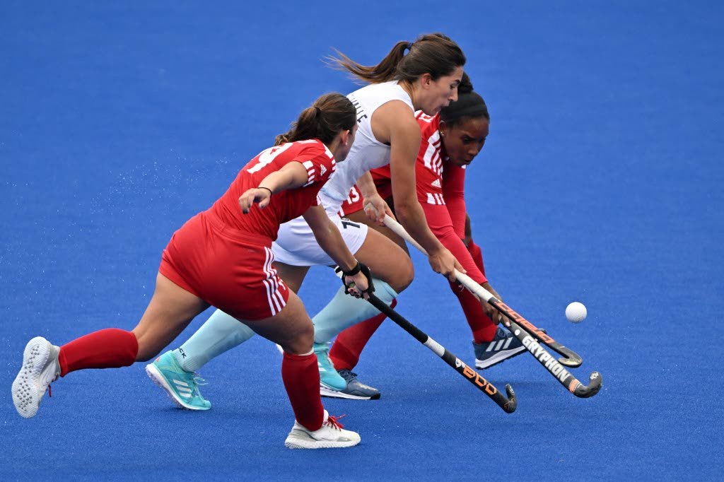 Uruguay’s Manuela Vilar del Valle (C) is challenged by TT’s Samantha Olton (L) and Giann Sealy during the field hockey women’s team preliminary group A match 3 during the Pan American Games Santiago 2023, at the Field Hockey Sports Centre in Santiago on Saturday. - 