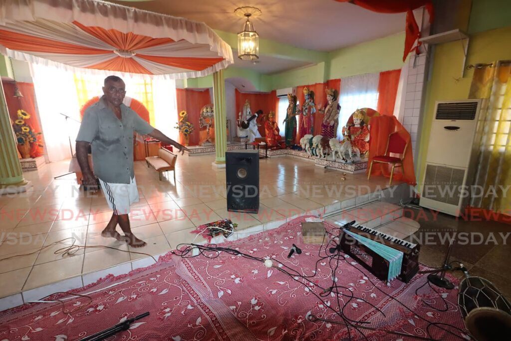 Caretaker Dhanraj Maharaj points to damaged audio equipment at D'Abadie Maha Vishnu Mandir on Monday after bandits broke into the temple. - Photo by Roger Jacob