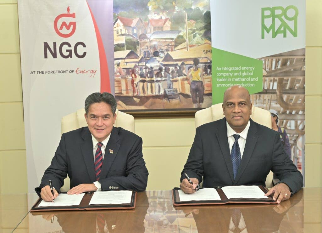 NGC president Mark Loquan, left, signs a gas sales agreement with MHTL managing director Jerome Dookie on October 20. Photo courtesy NGC - 